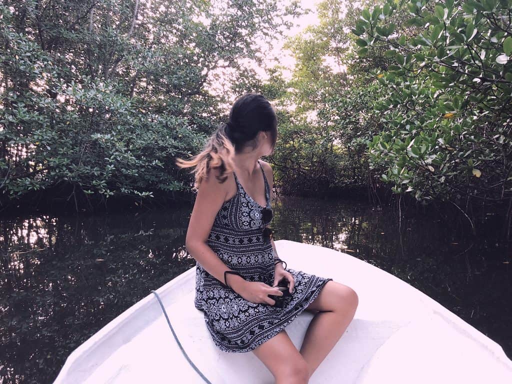 Girl on a boat through mangroves in Bali